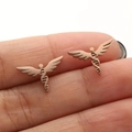 Detailed close-up of rose gold DNA helix wing stud earrings held for size reference - Rose Gold Wing DNA (663)