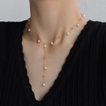 Elegant 18k gold plated Y-shaped pearl tassel necklace for women on black background - Gold Tassel Necklace