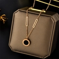 Minimalist rose gold Roman numeral necklace with black inlay on a brown jewelry box - Black & White Roman Numeral Style / Rose Gold
