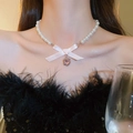 Elegant pearl necklace with pink silk bow and heart pendant worn by a model - 45# Necklace-Silver-Pink
