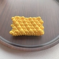 Detailed top view of a handmade yellow beaded pouch on a rustic dark wooden tray - Yellow