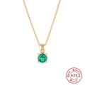 Macro shot of 925 sterling silver gold necklace with a round green gemstone pendant - Gold-May