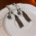 Detail of silver long tassel earrings with hollow beads and sparkling rhinestones - Silver Needle - Antique Silver / Antique Silver