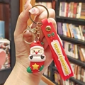 Cartoon Santa Claus PVC keychain with red wrist strap and Merry Christmas text - Santa in Sock (Gold Keychain)