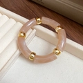 Minimalist elastic bracelet with marble pink acrylic tubes and golden metal beads - Brown