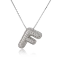 Macro detail of silver letter F pendant with iced-out zircon stones on box chain necklace - Letter F