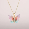 Detail of butterfly pendant necklace with gradient resin wings and gold foil accents - Gold Chain-Fantasy Pink