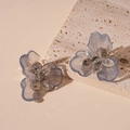 Macro shot of sweet translucent grey-blue resin flower hoop earrings on stone - Gray Resin Flower Hoop Earrings