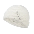 Detailed close-up of white knitted beanie featuring silver safety pin and metal rings accents - 55-58cm / White