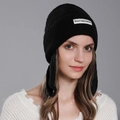 Women's black knit beanie with rabbit ear flaps and white brand label detail - Black