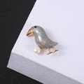 Elegant bird brooch with grey enamel, white pearl and green zircon in gold plating - Crow