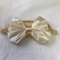 Silk satin sleep mask in champagne gold with a large decorative bow and elastic strap - Gold