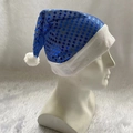 Detail of blue sequined Christmas hat with white plush trim on mannequin head - Adult Blue Sequins Hat