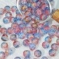 Close-up of 10mm pink and blue gradient glass beads with gold crackle for DIY jewelry - Cardamom Blue
