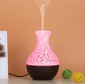 Detail of the pink crackle glass ultrasonic diffuser with wood base emitting mist - USB Powered / Dark Crackle