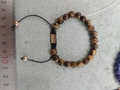 Adjustable tiger eye beaded bracelet with rose gold slider on gray felt background - Tiger Eye Rose Gold