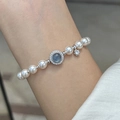 Silver pearl bracelet with blue zircon centerpiece and star pendant on woman wrist - Sparkling Aquamarine Pearl Bracelet