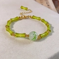 Macro detail of Chinese style bamboo-shaped green glass beads and gold adjustable chain - Green-Bamboo-Painted