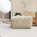 Quilted floral cosmetic bag detail featuring orange flower print and soft cotton fabric - Handheld Yellow Floral
