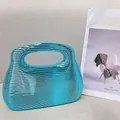 Metallic blue acrylic clutch bag with horizontal wave texture and cutout handle design - Sky Blue