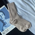 Beige ribbed knit knee-high socks for women with vintage magazine on white fabric - Short Apricot