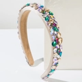 Detailed macro view of baroque headband with colorful rhinestones on satin fabric - Brown