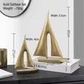Set of two modern golden ceramic sailboat sculptures for home decor weighing about 765g - A Pair Of Golden Sailboats