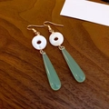 Detailed close-up of fashion earrings with white circular studs and green water drop pendants - Translucent Green Teardrop Pearl (Ear Hook)