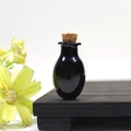 Mini oval black glass wishing bottle with natural cork stopper on wooden stand - Black Oval Bottle With Cork