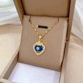 Macro shot of gold-plated evil eye heart necklace with sparkling crystals in a gift box - Evil Eye Heart Pendant Style (H209)