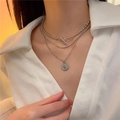 Three-layer silver necklace with coin pendant and T-bar toggle clasp on model - Silver