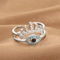 Silver crown evil eye open ring with blue and white zircons on warm fabric background - Evil Eye Tiara Shape (Q-J090) / White Gold