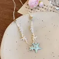 Détail d'un collier de plage avec pendentifs étoile de mer bleue, perles et coquillages - 10# Collier-Blanc-Bleu (Étoile de Mer Perle Corde Tissée Chaîne de Clavicule)
