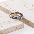 Detailed macro view of silver ring featuring a large square zircon and textured spiral band - Silver/White Zirconia