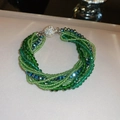 Detail of multi-strand beaded bracelet with green and blue crystals and rhinestone clasp - Multi-strand Braided Bracelet / Green