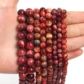 Macro shot of natural red tiger eye beads strand for DIY jewelry making and craft projects - Cherry Tiger Eye