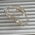 Detailed close-up of transparent cloud-shaped hair claw with gold spring mechanism - Champagne