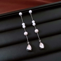 Dettaglio di orecchini vintage con perle e ciondoli a goccia d'argento su pelle nera - Orecchini a Bottone con Perle a Goccia d'Acqua (Perno in Argento-Argento Rosa Bianco)