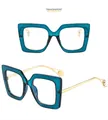 Detail of square blue frames with gold metal temples and white pearl accents on tips - Blue Frame Transparent Lenses