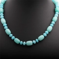 Macro shot of turquoise beads necklace with oval and round stones on a black neck bust - Light Blue Stone Necklace (NSN0010)