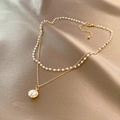 Elegant double-layered necklace featuring gold chain and pearls with a round pearl pendant - Gold Pearl Necklace