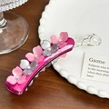 Pink and grey floral acetate hair clip with rhinestones shown on a white decorative plate - Rose Red