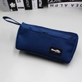 Detail of navy blue large capacity stationery bag with hand strap and woven brand label - Navy Blue