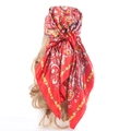 Red silk square scarf with vintage paisley floral patterns on a display mannequin head - Red