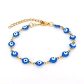 Detail of gold chain bracelet with blue evil eye enamel beads on white background - Sky Blue