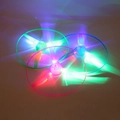 Close-up of LED glowing bamboo dragonfly toys in green, pink, and blue light effects - Glowing Hand Push Flying Saucer