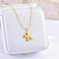 Elegant gold butterfly pendant necklace with beaded fine chain on a jewelry display box - Polished Butterfly