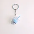 Close-up of a blue bubble tea cup keychain with striped straw and silver metal ring - Light Blue