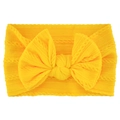 Close-up of yellow soft knitted baby headband with a large bow and ribbed texture - Gold Yellow