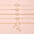 Golden multi-style bracelets set featuring cubic zirconia charms on soft pink background - O-chain Round Ring / Gold